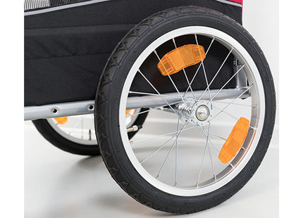 Een close-up van een Trixie - Hondenfietskar wiel met oranje spaken.